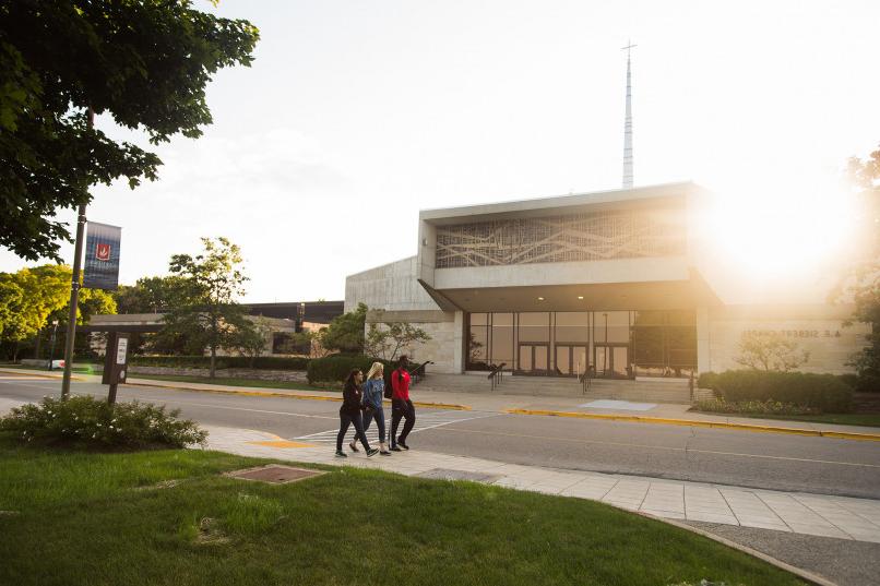 Students walking in front of chapel.